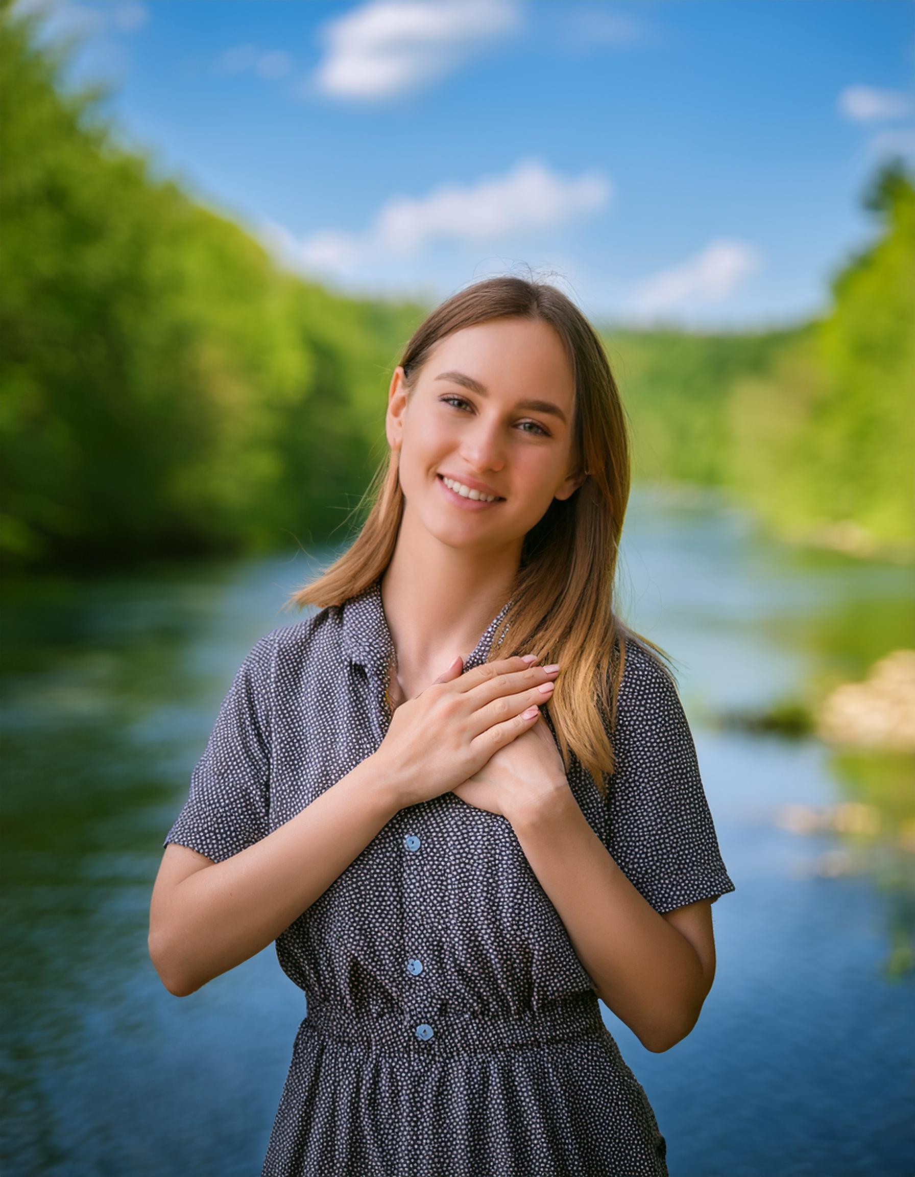 a young woman smiling and showing gratitude blur background of the river in spring season on blue s 27 12 2024 at 08 29 48